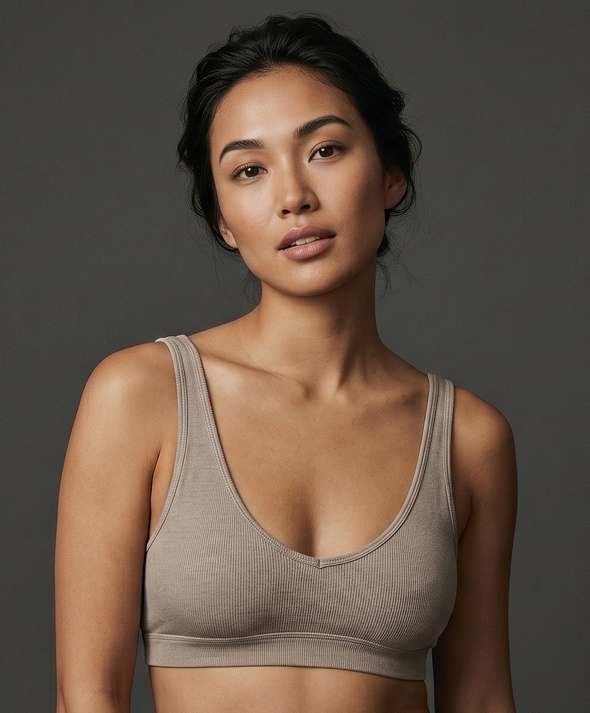 Model wearing a neutral-colored bralette.
