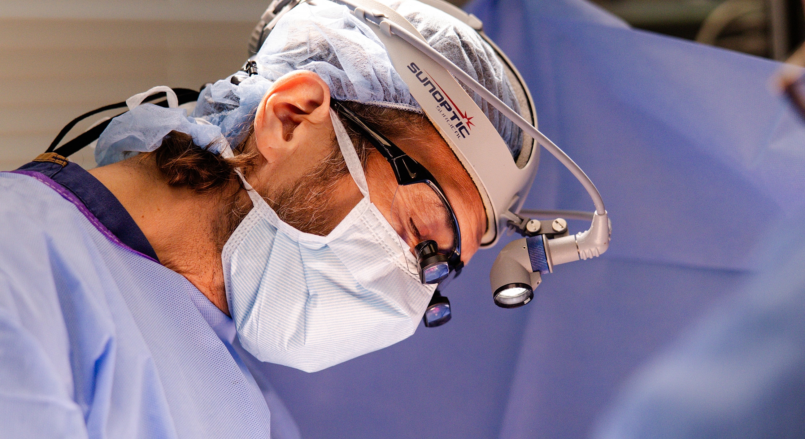 Surgeon focused during a medical procedure.