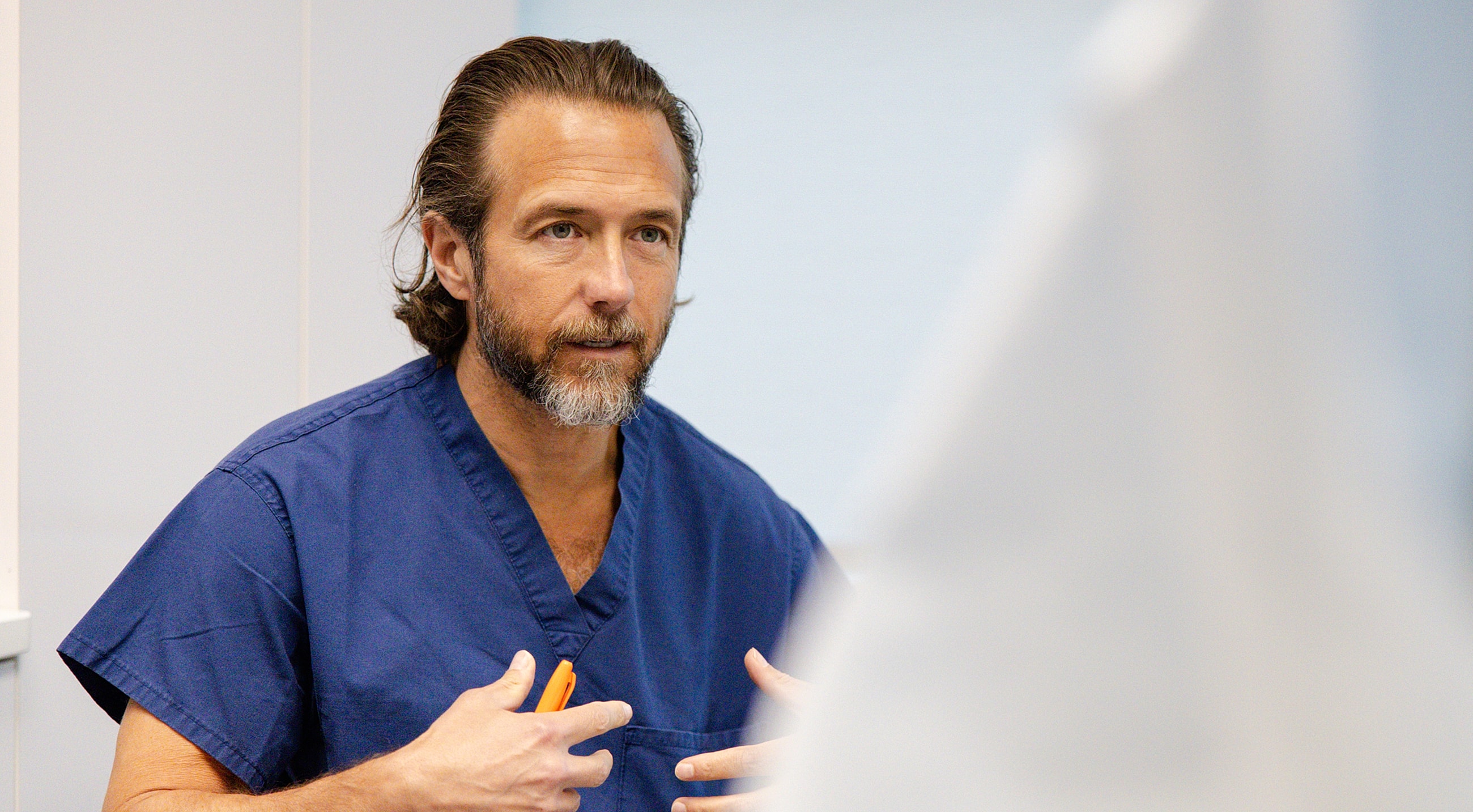 Doctor discussing with a patient in clinic setting.